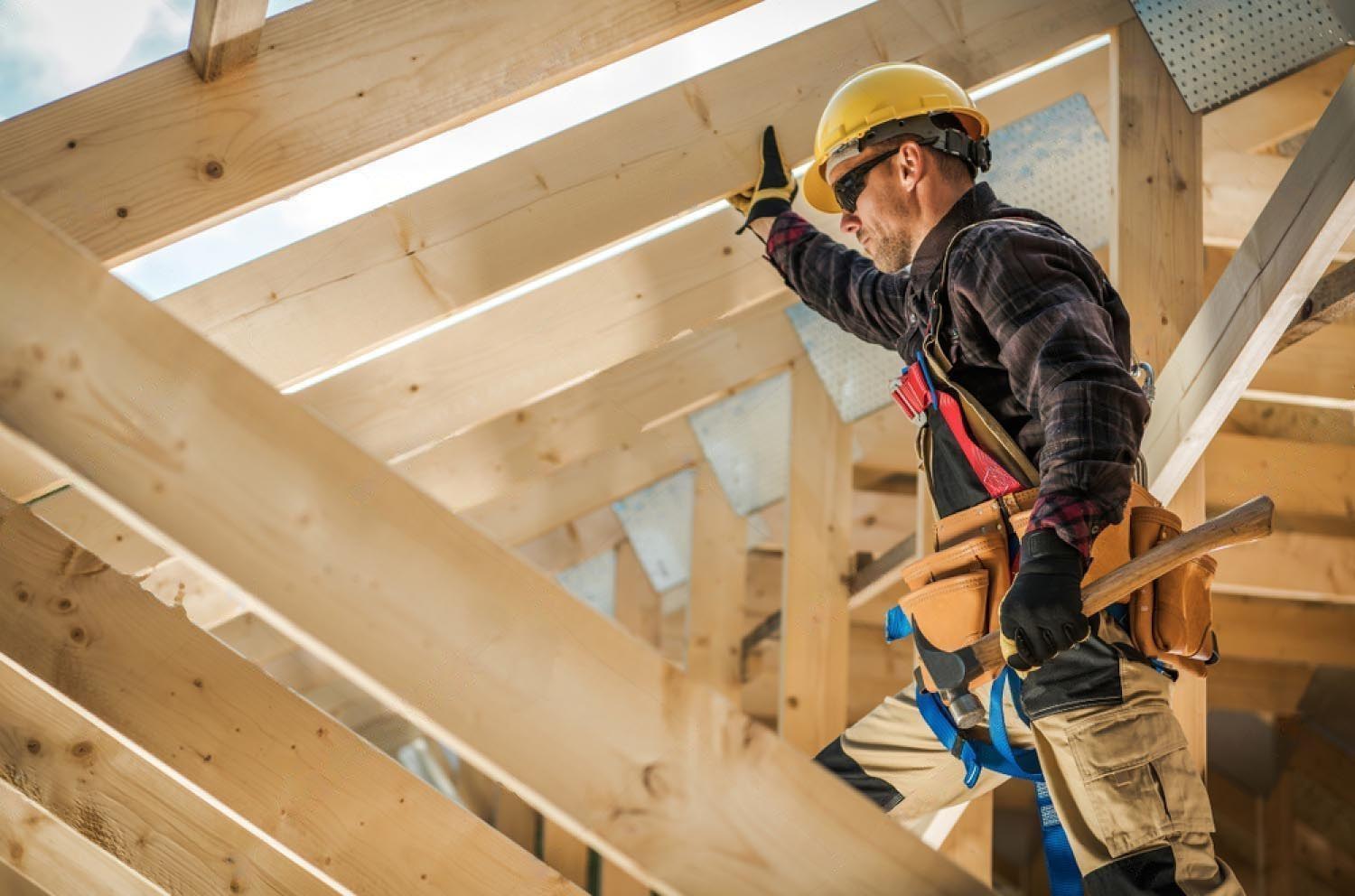 stock-photo-construction-worker-on-duty-caucasian-contractor-and-the-wooden-house-frame-industrial-theme-1533114308-transformed
